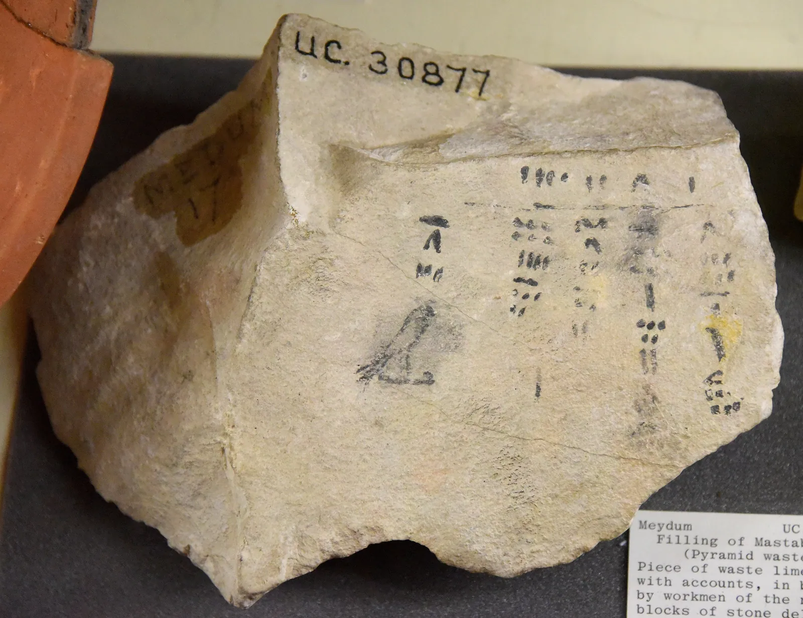 Byggarnas pappersarbete: en kalkstensflisa från byggspillet i Mastaba 17 i Meidum, med arbetarnas bläckanteckningar över block som levererats till Meidumpyramiden (4:e dynastin; Petriemuseet, London). Samma förvaltningsvärld talar en generation senare genom Merers papyrer.